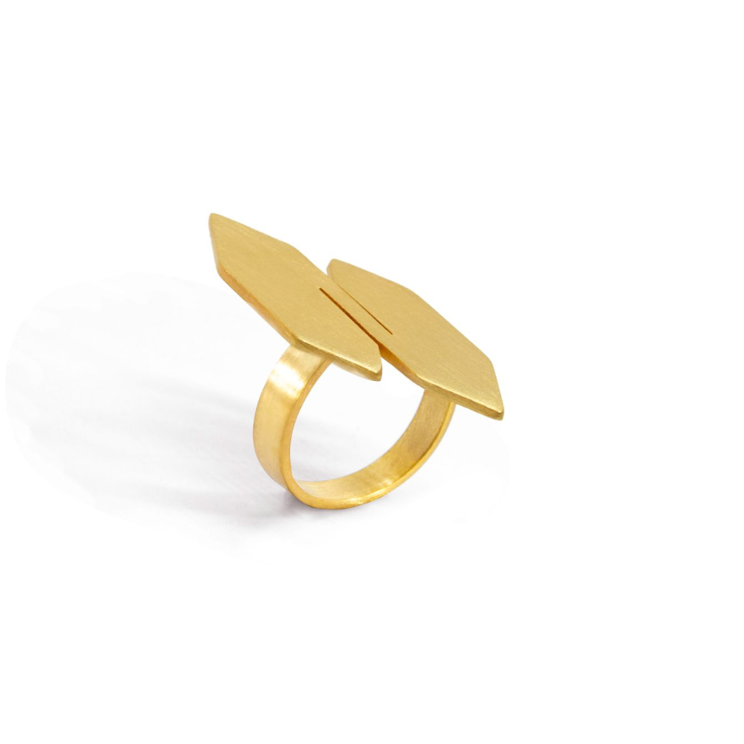 Gold plated modular ring with twin sculptural panels from transformable jewelry collection, styled with matching pendant necklace.