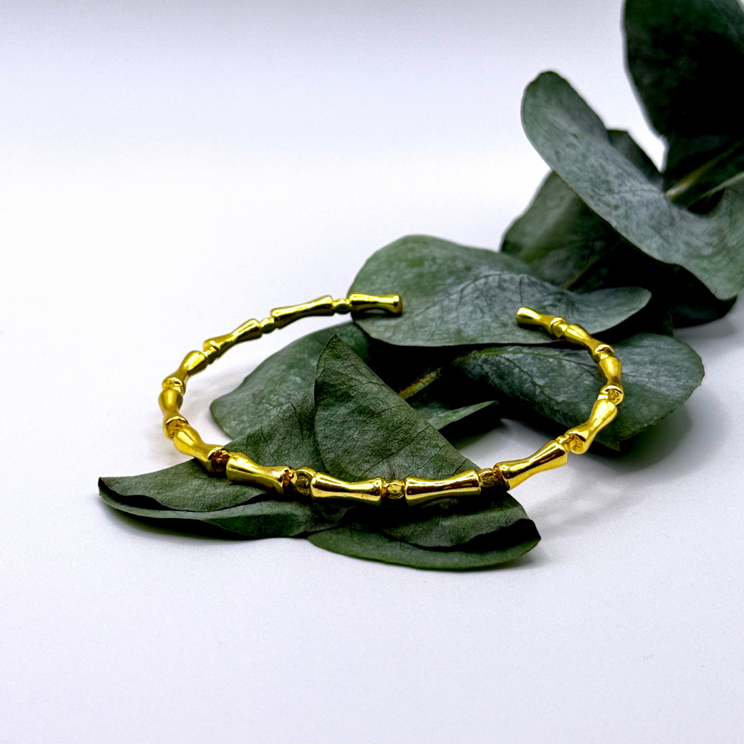 Liner Bracelet — 18k gold-plated bracelet with bamboo-style links and sleek, structured finish.