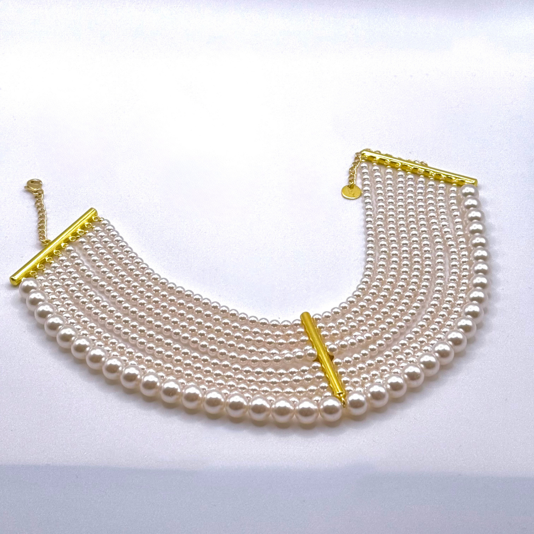 Pearlfect Choker with ten rows of pearls and gold bar detailing in a layered statement design