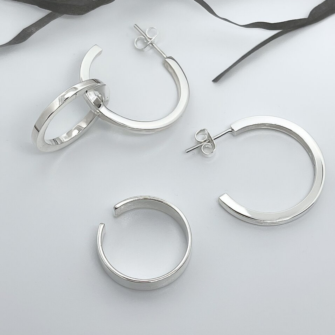 Earrings Set in handmade 925 sterling silver featuring mixed hoop and sculptural drop designs.