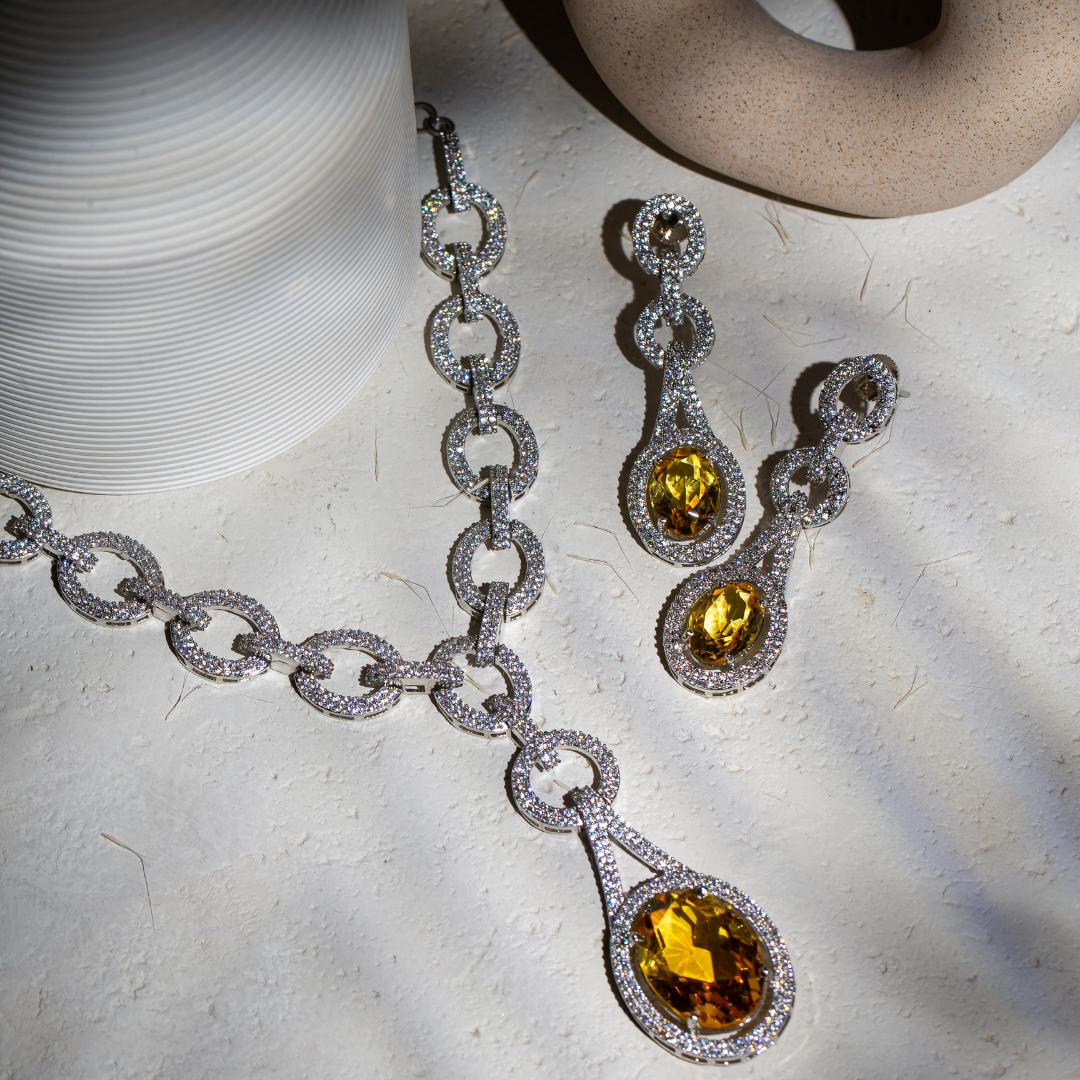 The Indra Necklace Set with yellow glass stones and silver plated chain-link details, includes earrings