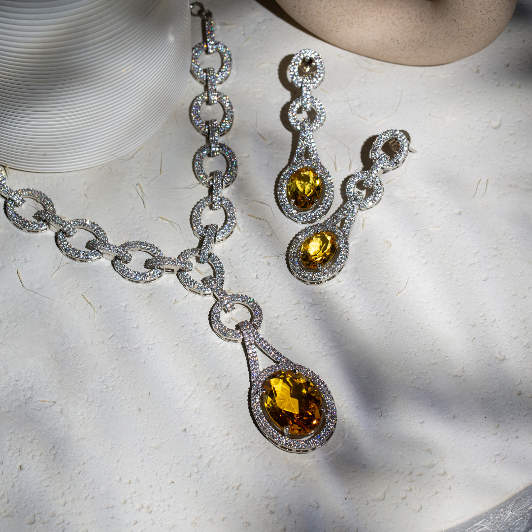 The Indra Necklace Set with yellow glass stones and silver plated chain-link details, includes earrings