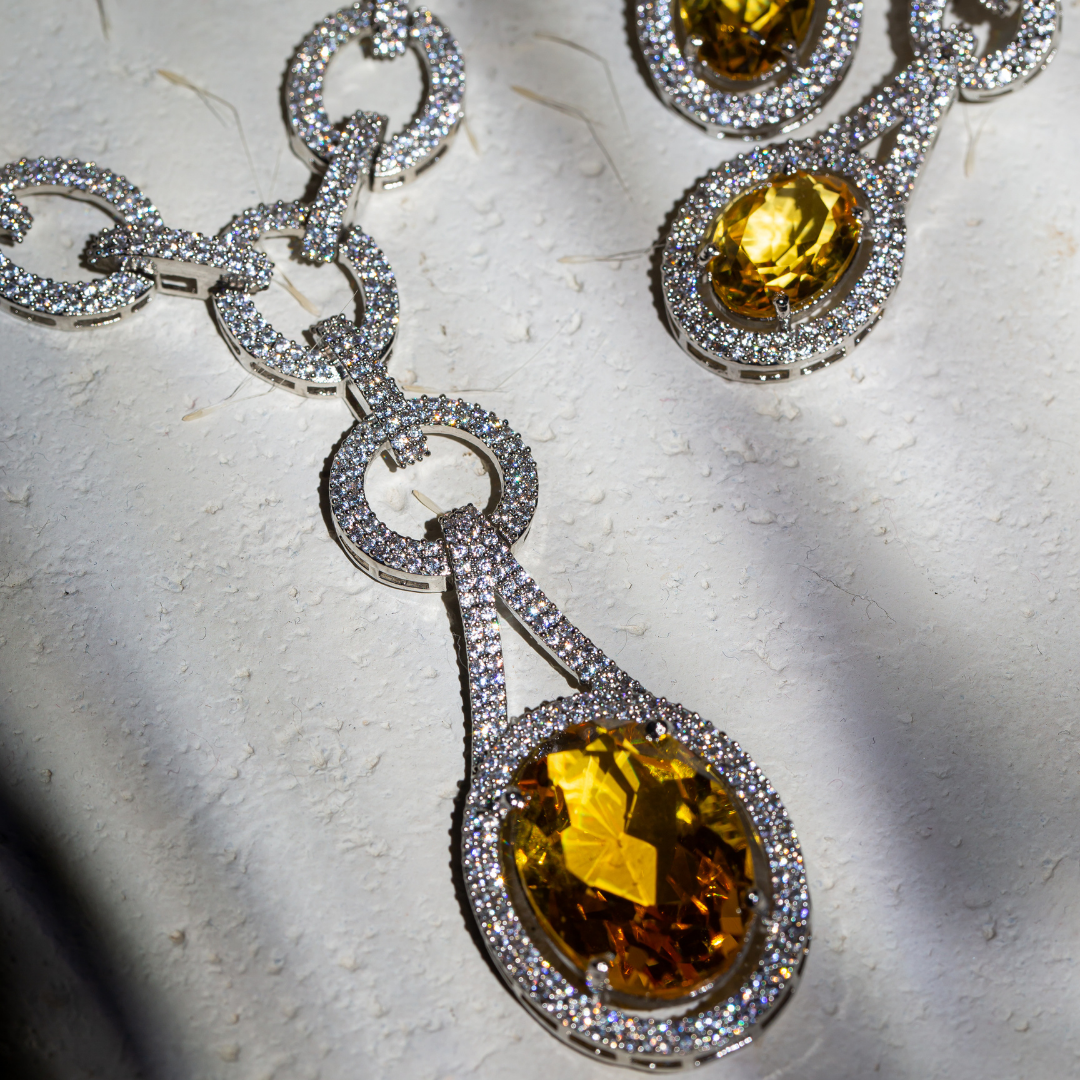 The Indra Necklace Set with yellow glass stones and silver plated chain-link details, includes earrings