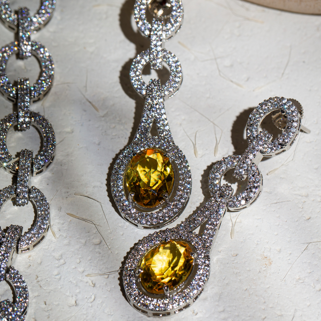 The Indra Necklace Set with yellow glass stones and silver plated chain-link details, includes earrings