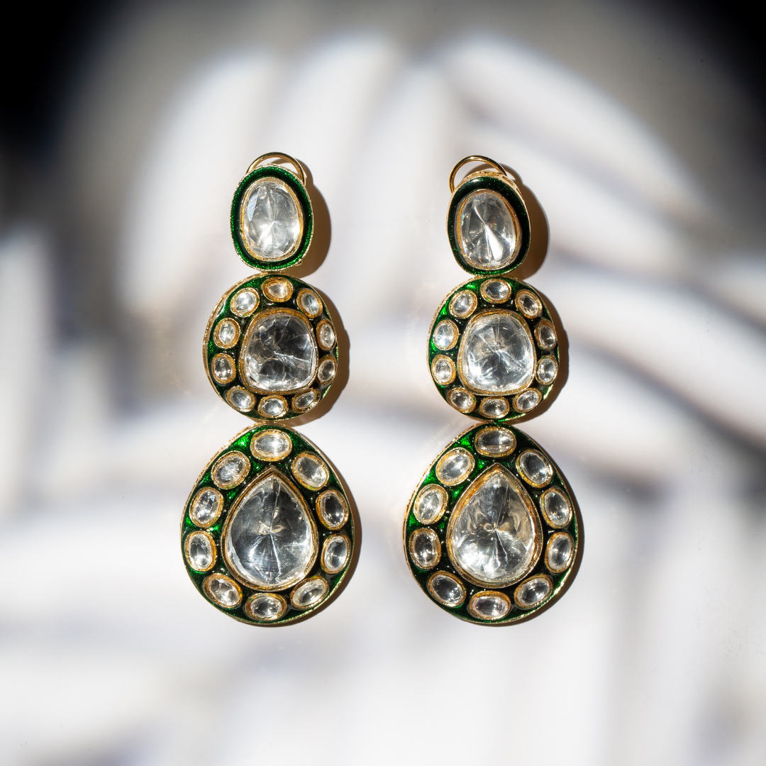 the rudra earrings featuring three-tier glass polki earrings with green enamel and gold frame