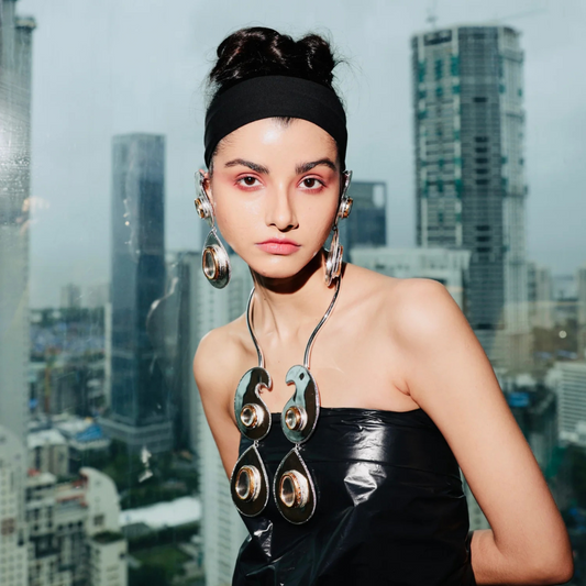 Bold fashion jewelry look with oversized metallic necklace and earrings