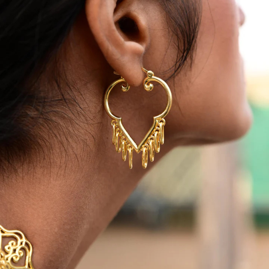 Gold-plated heart-shaped earring with dangling charms