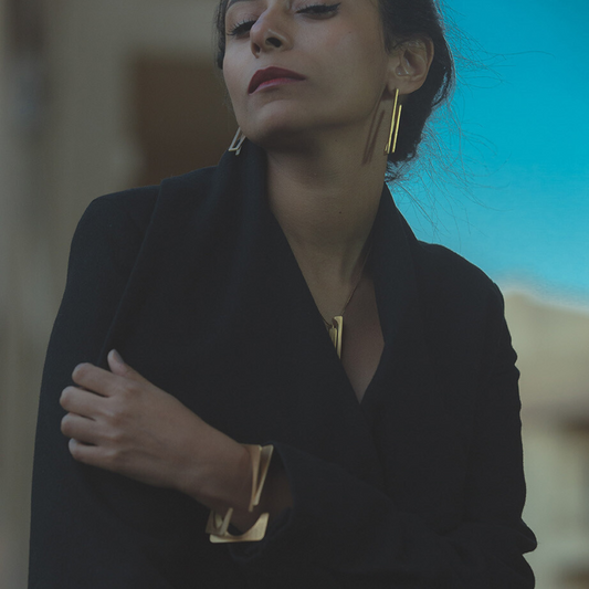 
Bold gold plated brass bracelet with architectural rotating design, statement cuff for contemporary styling

