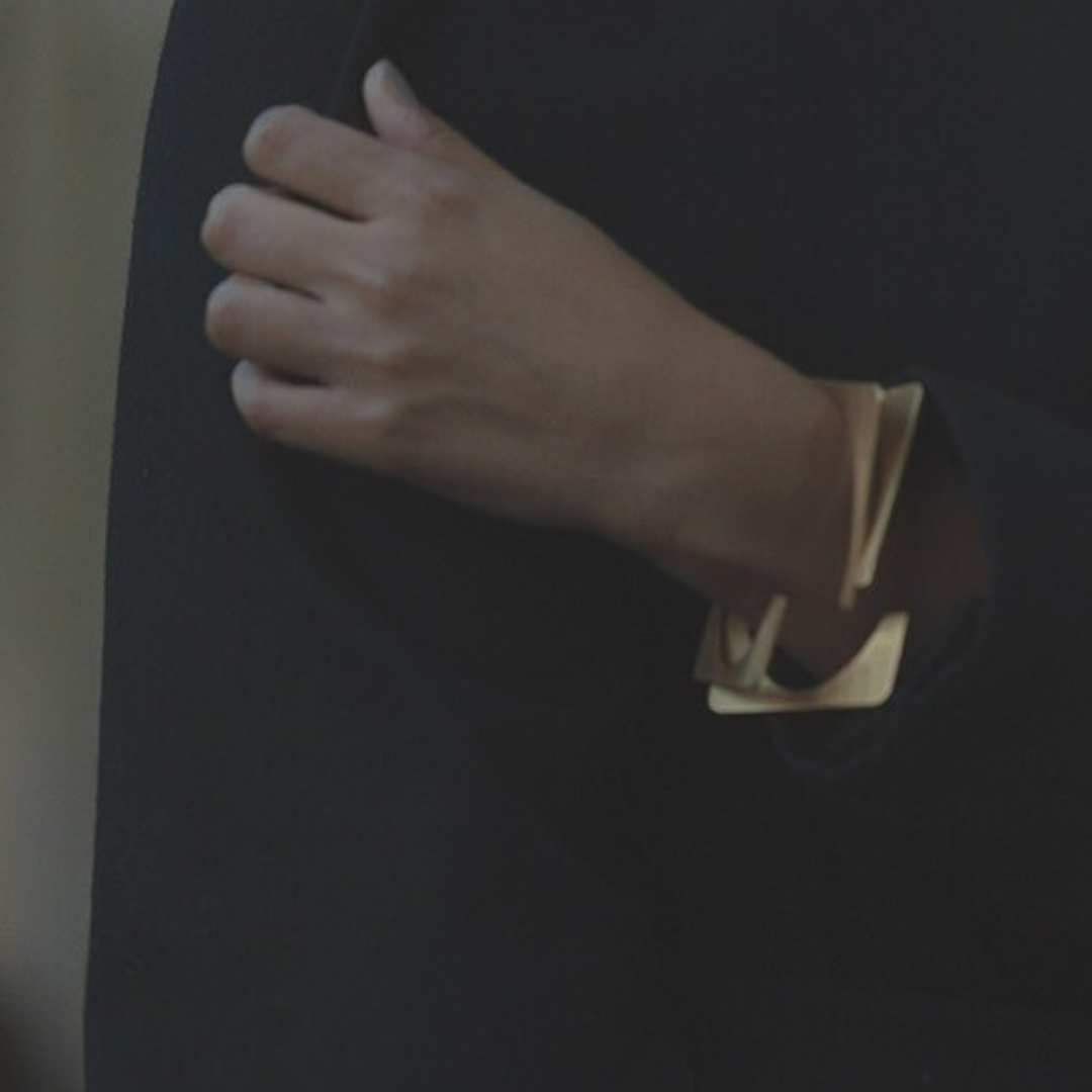 
Bold gold plated brass bracelet with architectural rotating design, statement cuff for contemporary styling


