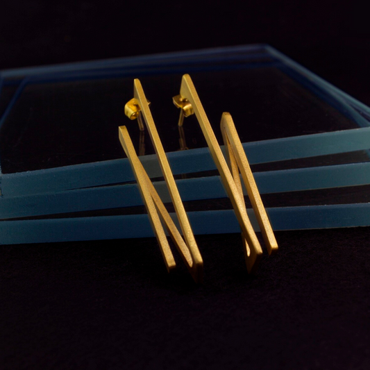 Contemporary gold plated brass earrings with angular 2D rotation design, lightweight and sculptural

