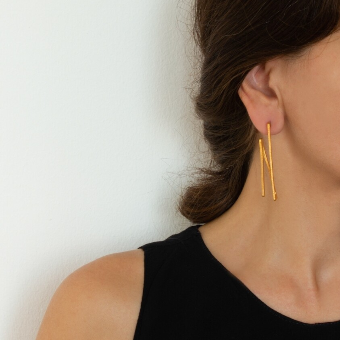 Contemporary gold plated brass earrings with angular 2D rotation design, lightweight and sculptural

