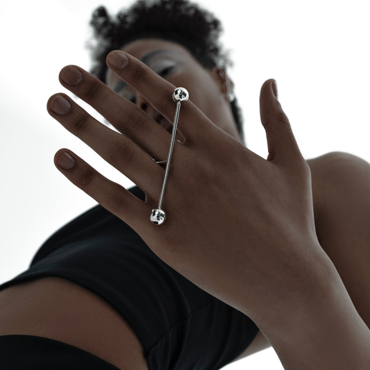 T.J. Ring in handmade 925 sterling silver featuring a horizontal bar design with dual sculptural spheres.
