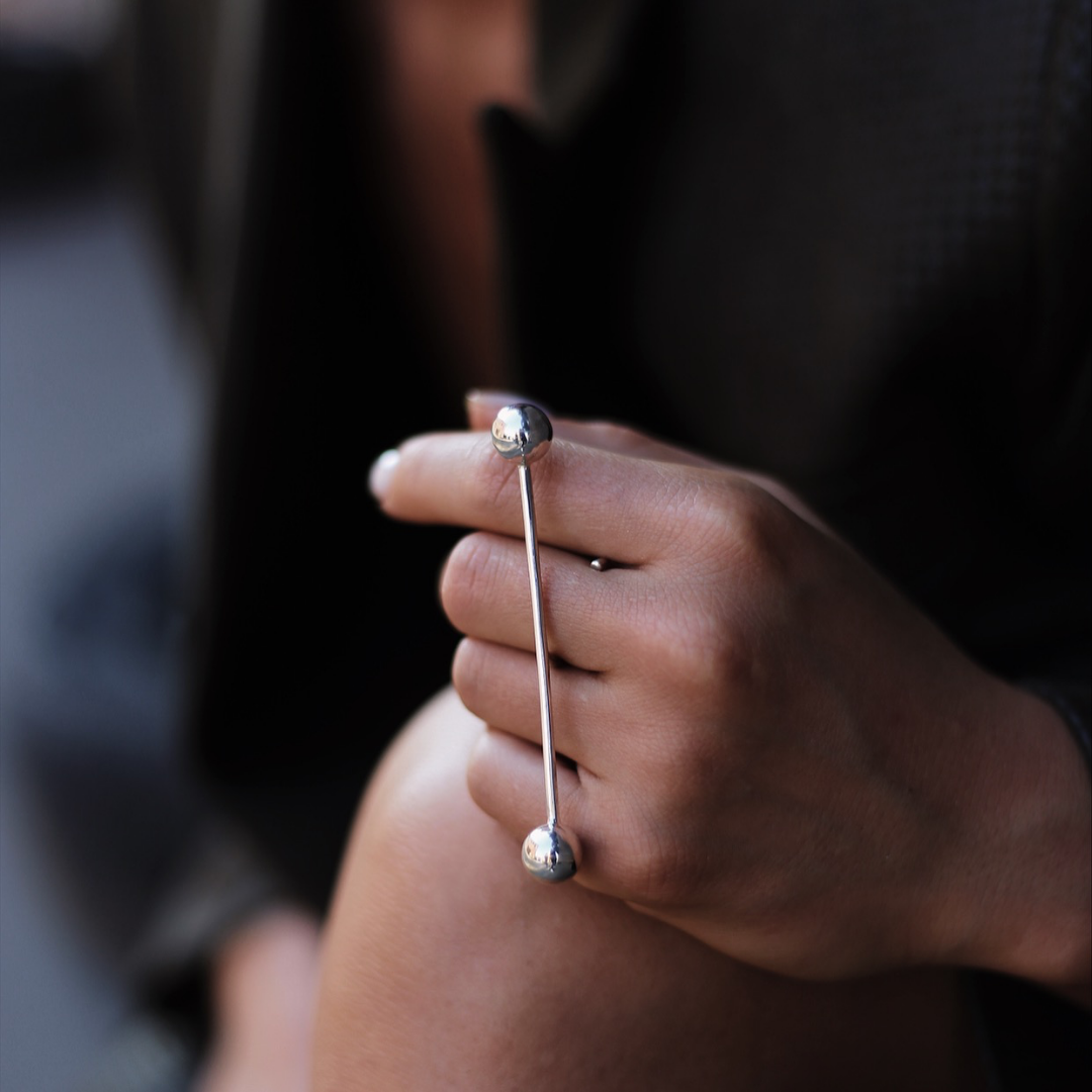 T.J. Ring in handmade 925 sterling silver featuring a horizontal bar design with dual sculptural spheres.
