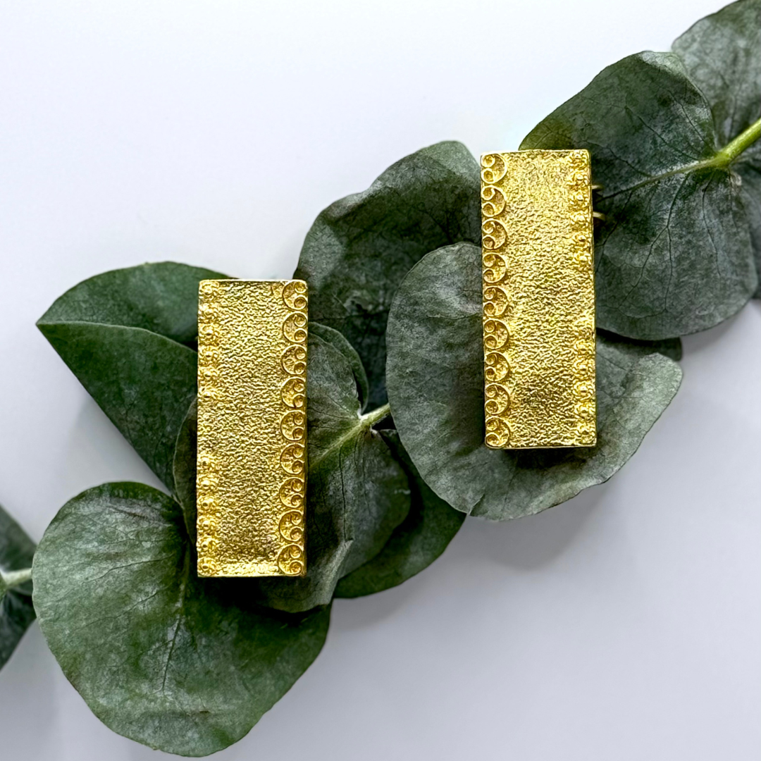 Gold-plated rectangular ear cuffs with textured finish and crescent-edge detailing

