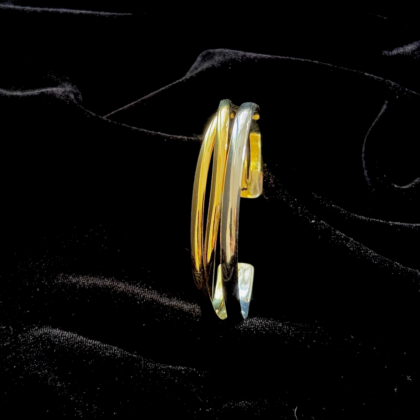 The Code Switch Hand Cuff in 18k gold and silver plated brass with fluid, sculptural curved form

