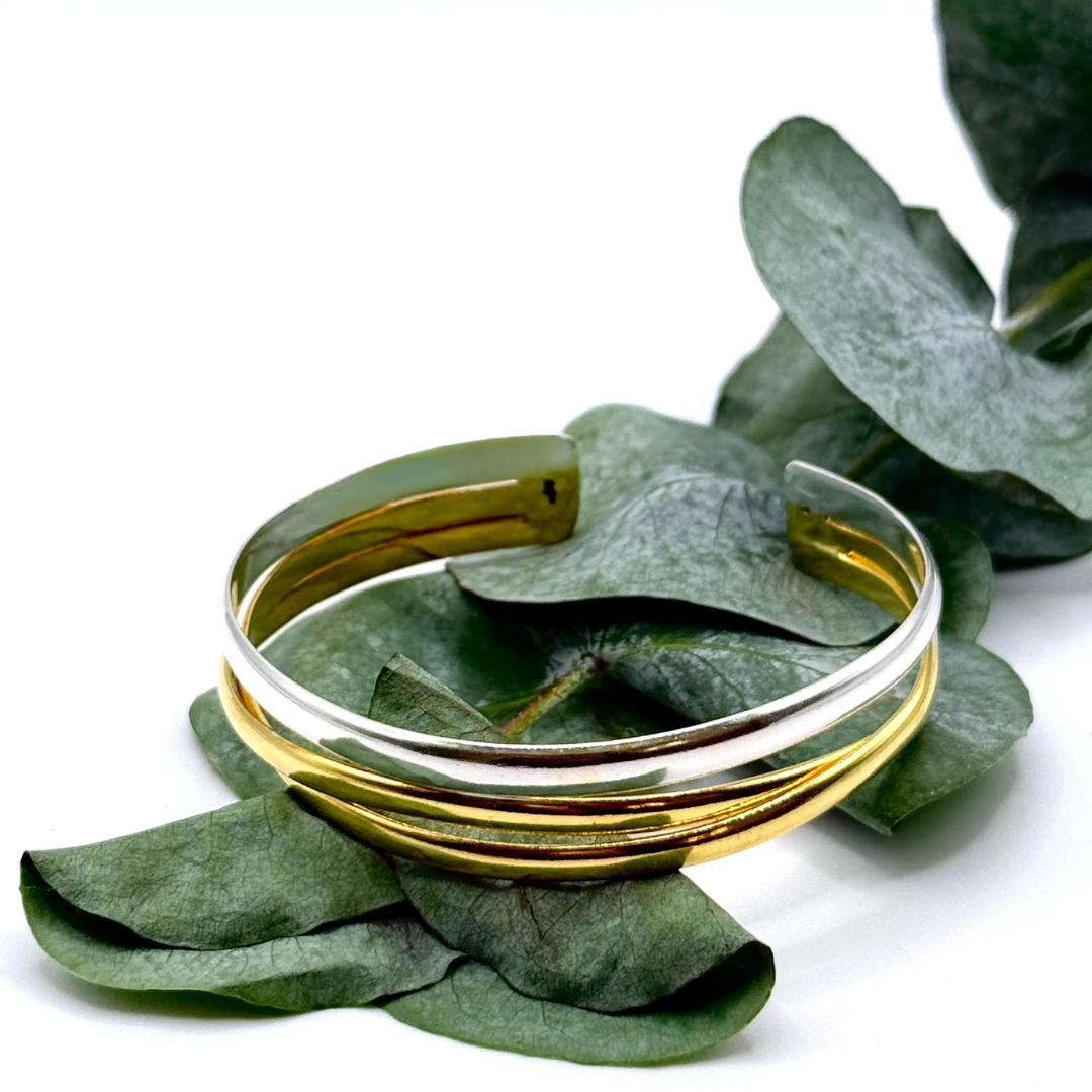The Code Switch Hand Cuff blends gold and silver in a sculptural 18k plated design made for bold, modern looks.