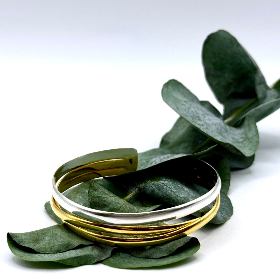 The Code Switch Hand Cuff blends gold and silver in a sculptural 18k plated design made for bold, modern looks.
