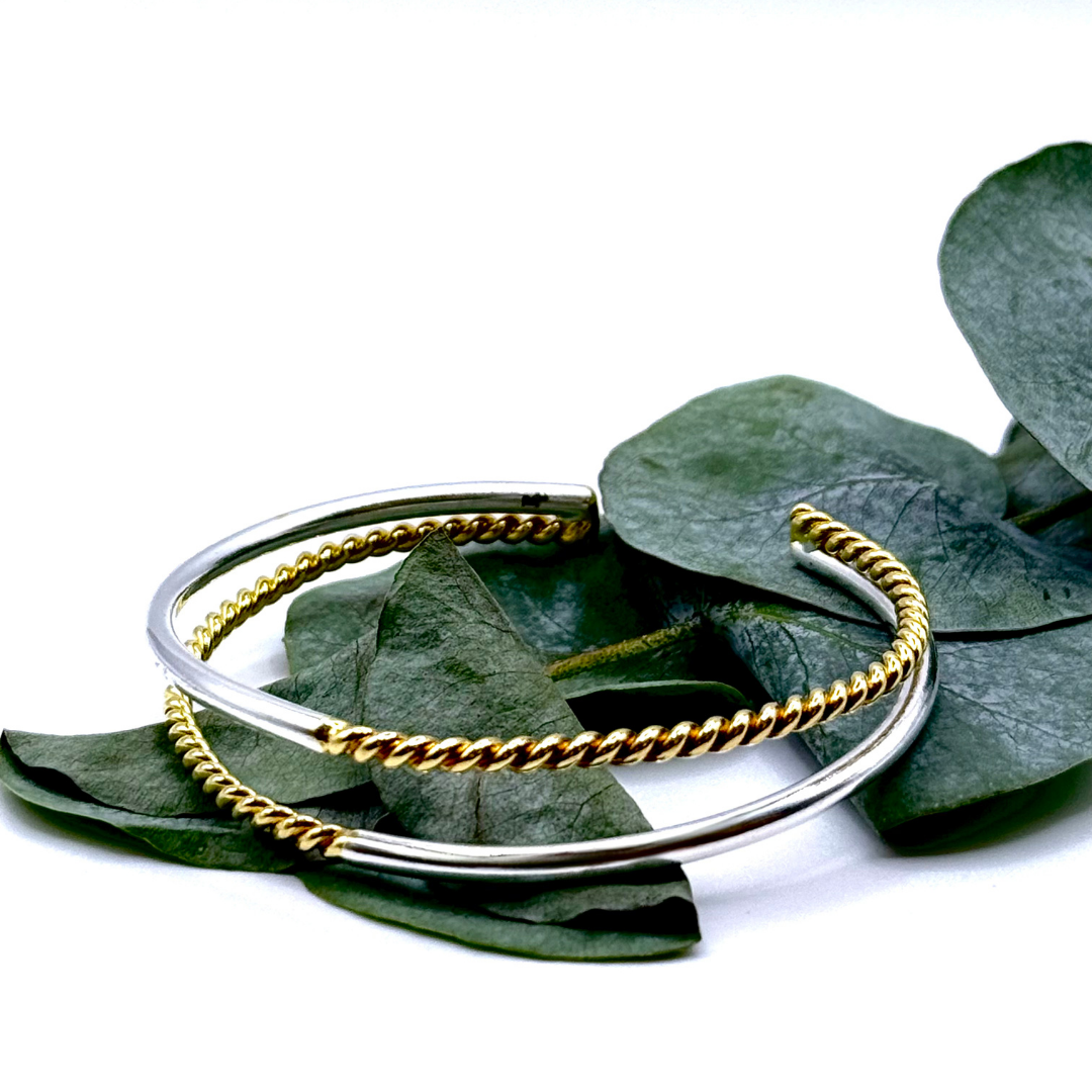 Duality Hand Cuff in 18k gold and silver plating with twisted and smooth dual-band design
