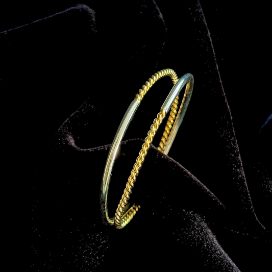 Duality Hand Cuff in 18k gold and silver plating with twisted and smooth dual-band design

