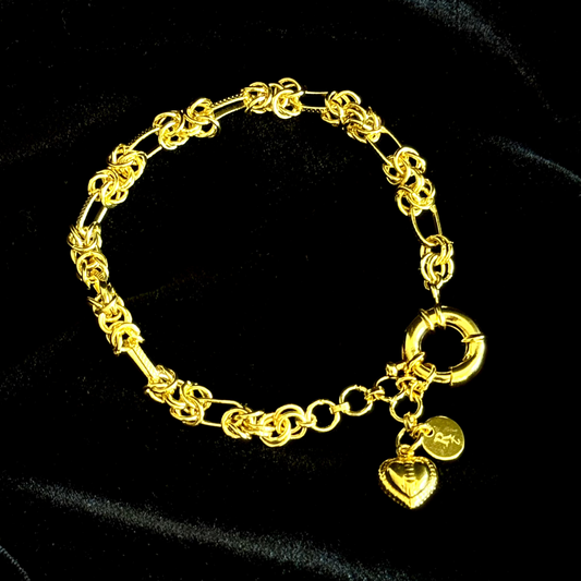 Gridlocked Bracelet in 18k gold plating featuring chunky knot links and heart charm drop


