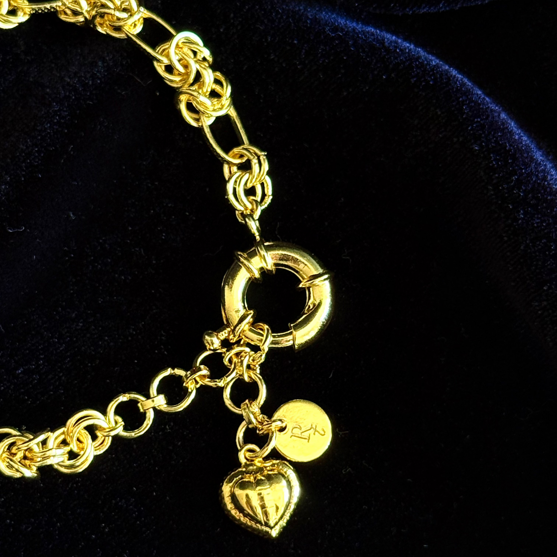 Gridlocked Bracelet in 18k gold plating featuring chunky knot links and heart charm drop

