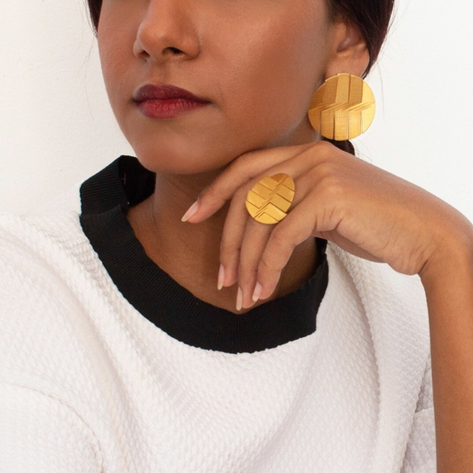 Bold gold plated brass ring with engraved linear pattern, part of the LIQUIFY circle collection

