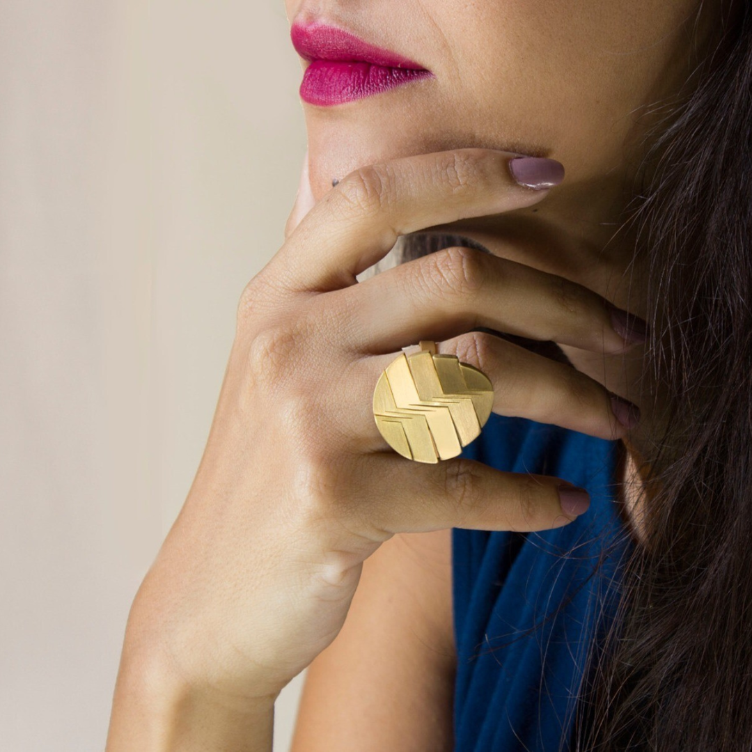 Bold gold plated brass ring with engraved linear pattern, part of the LIQUIFY circle collection

