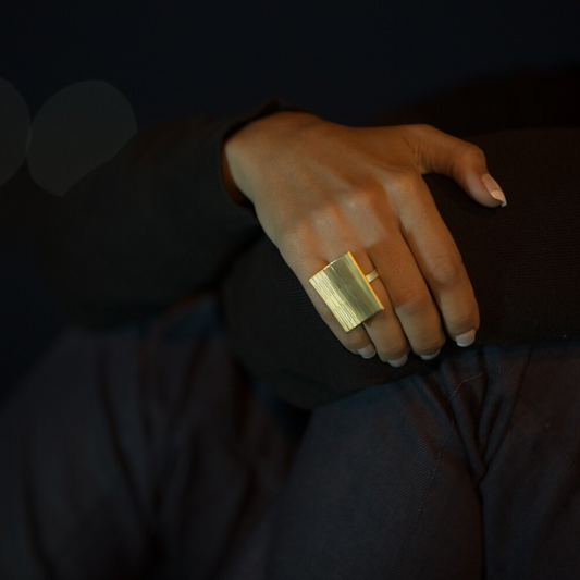 Statement square ring in gold plated brass featuring linear texture, from the LIQUIFY collection

