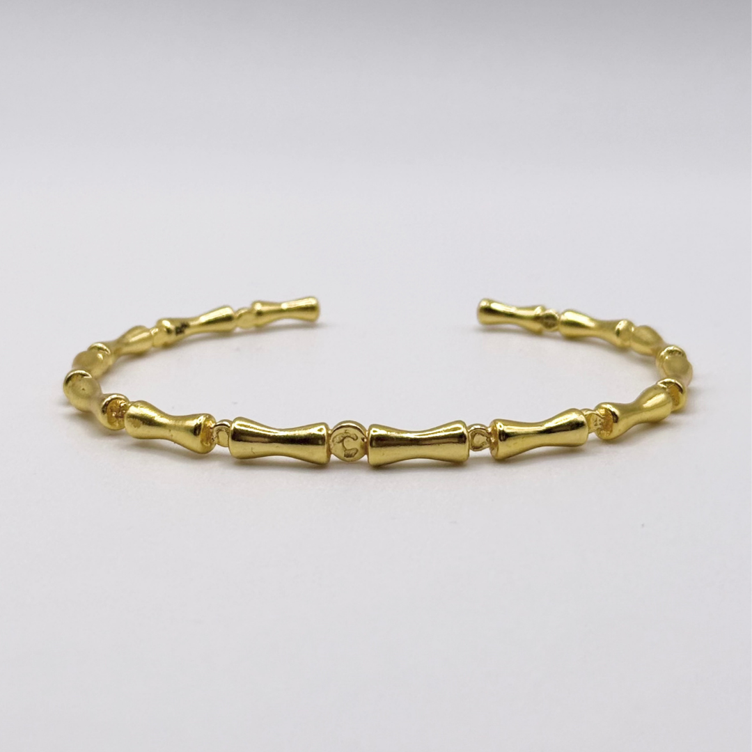 Liner Bracelet — 18k gold-plated bracelet with bamboo-style links and sleek, structured finish.
