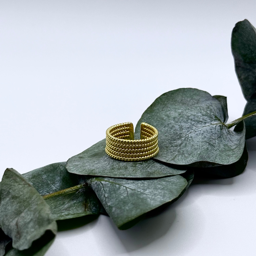 Gold-plated Looped Ring with layered coil design placed 