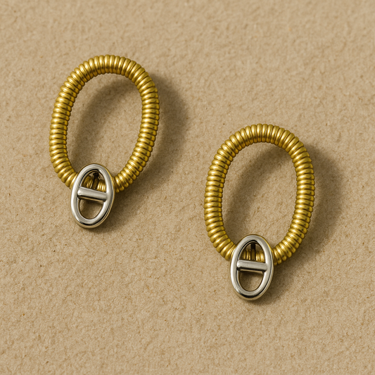 Two-toned gold coil loop earrings with silver oval toggle 

