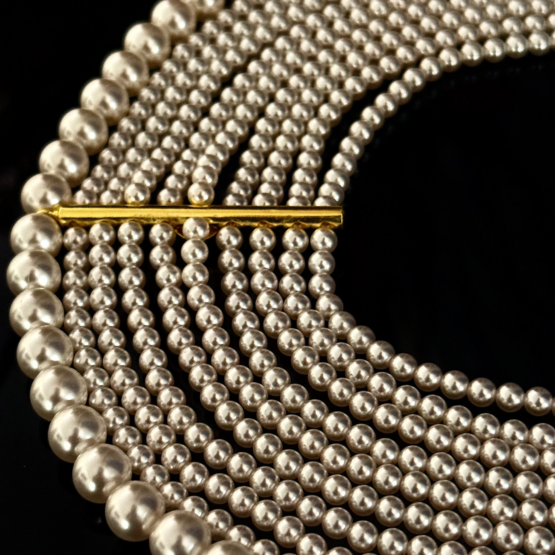 Pearlfect Choker with ten rows of pearls and gold bar detailing in a layered statement design

