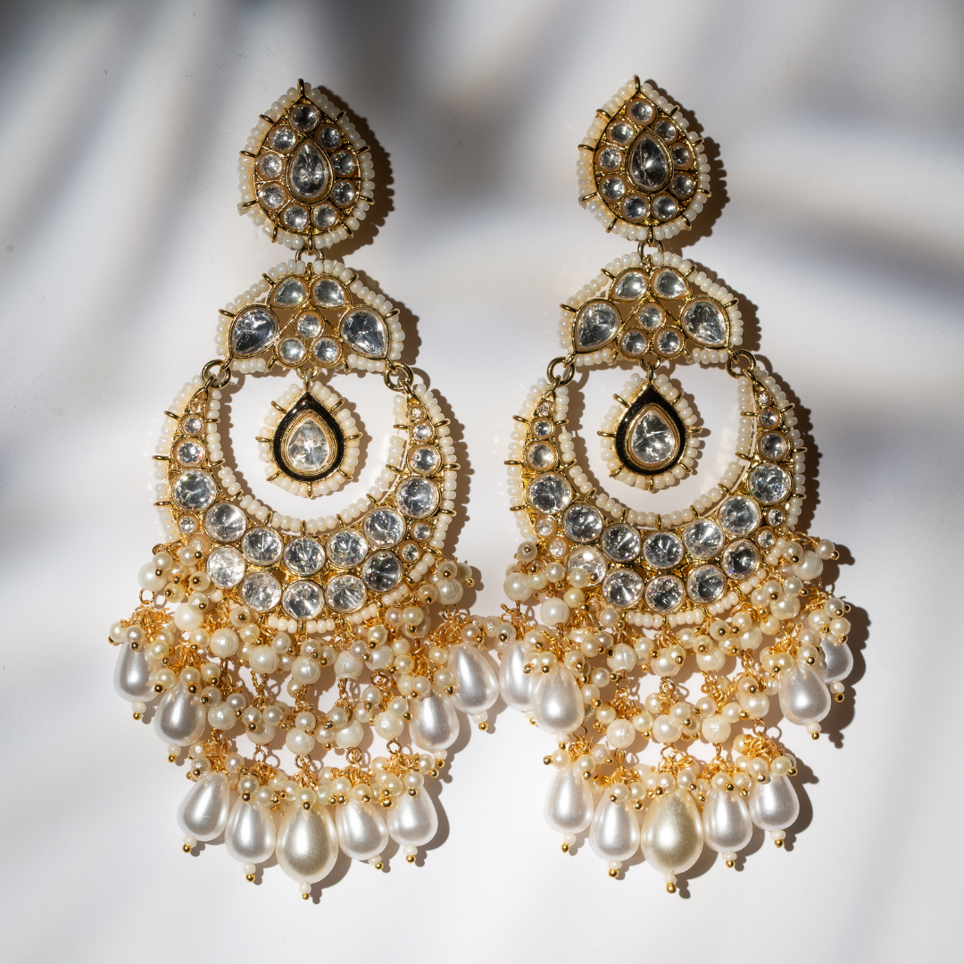 Gold plated chandbali earrings with pearl clusters and kundan detailing.