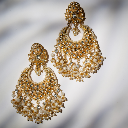  Sleek gold plated earrings with crystal and glass polki stones.