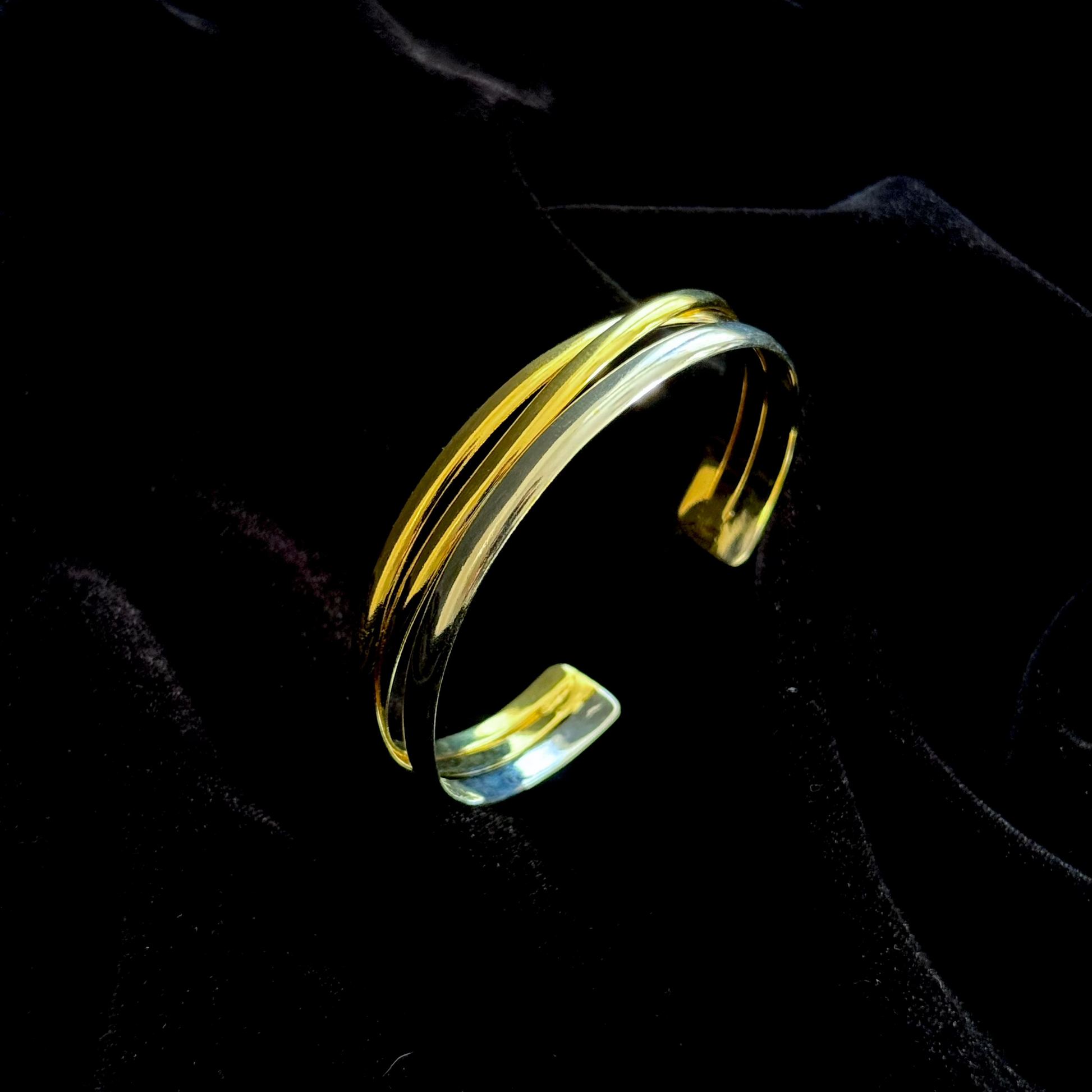 The Code Switch Hand Cuff in 18k gold and silver plated brass with fluid, sculptural curved form

