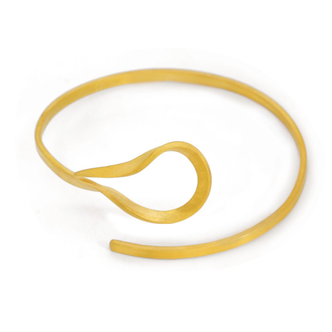The Curl gold plated brass bracelet with fluid sculptural form, from minimal imitation jewelry collection.