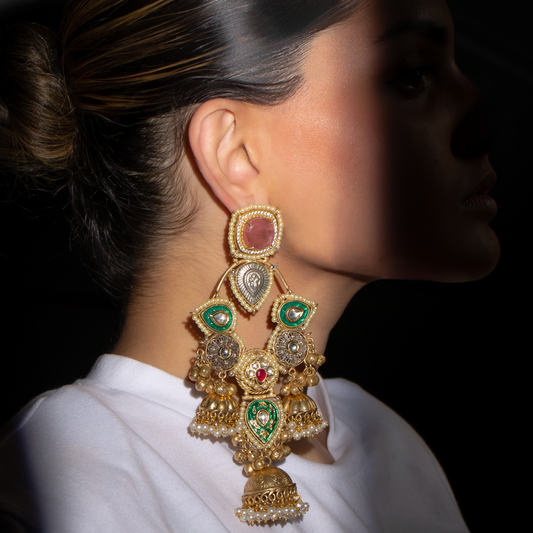 Bold gold plated Unravel Earrings with green and ruby crystal accents.

