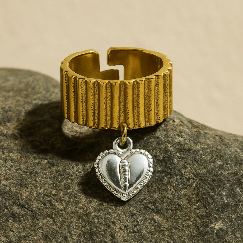 Chunky two-toned gold ring with silver heart charm and ribbed texture
