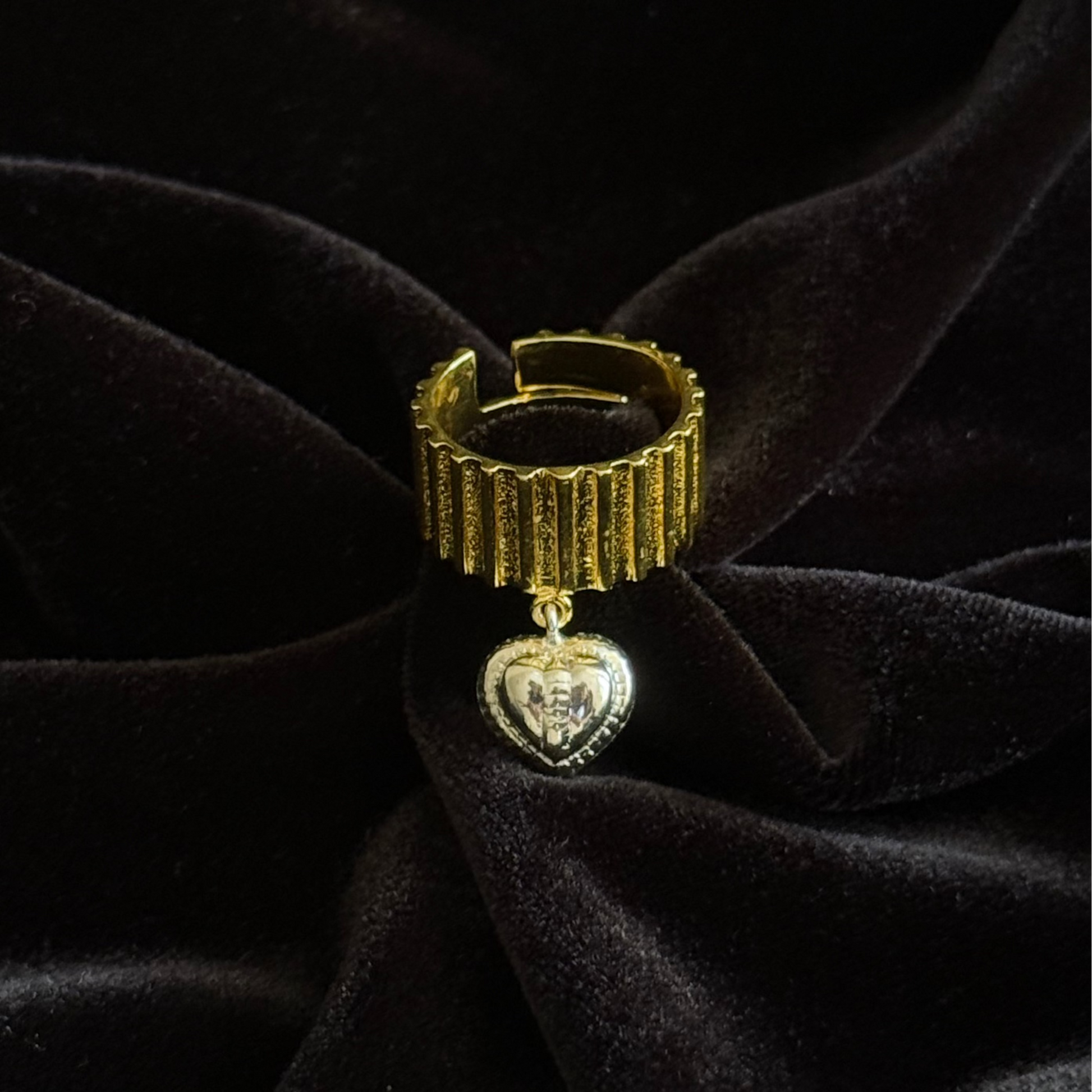 Chunky two-toned gold ring with silver heart charm and ribbed texture
