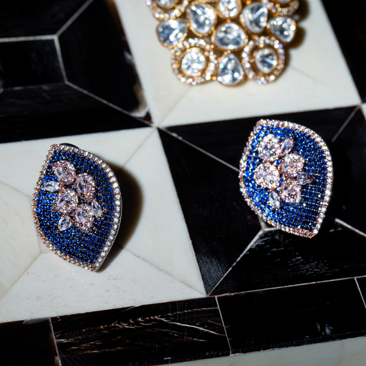 The Fitoor Studs in sapphire blue with rose gold frame and crystal edge

