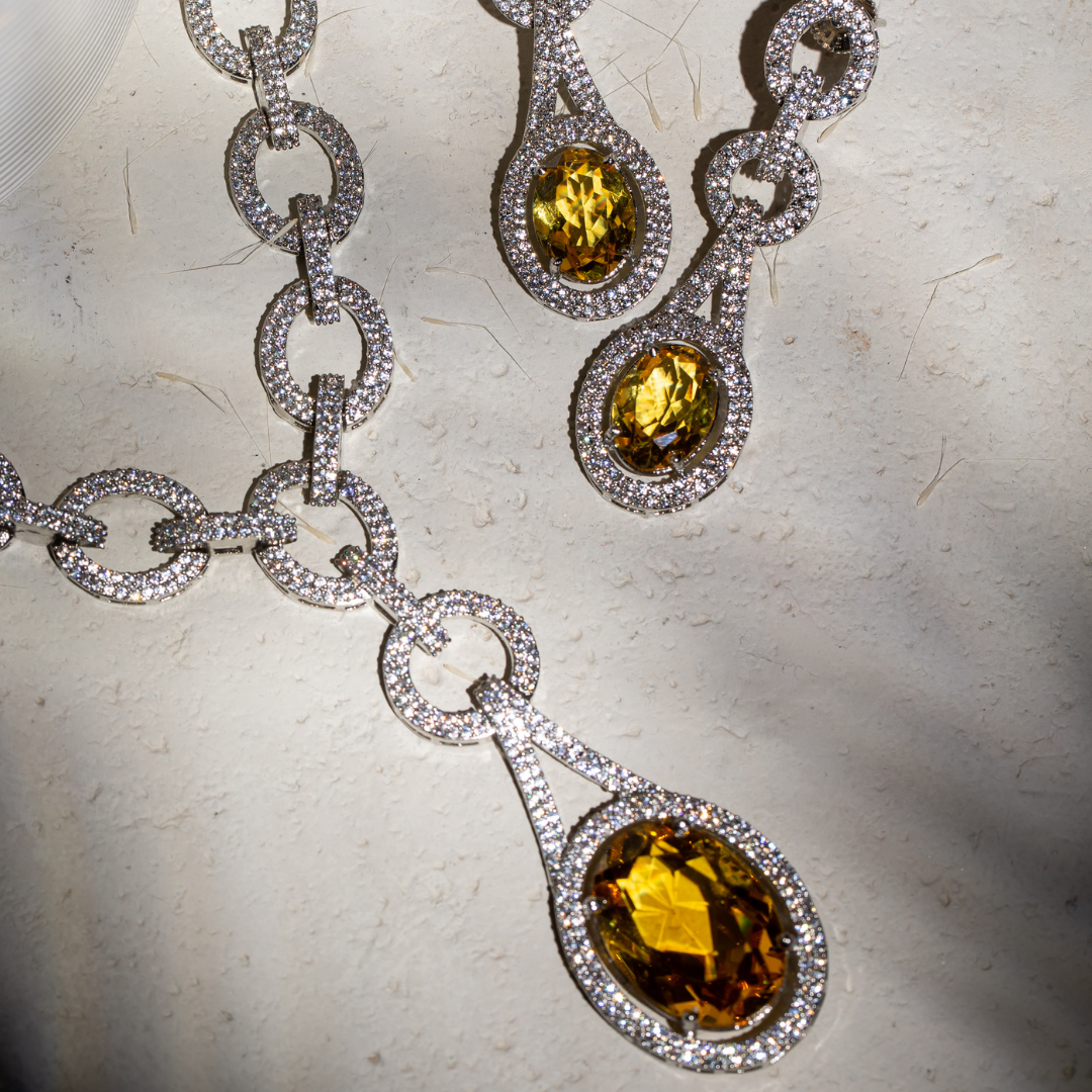 The Indra Necklace Set with yellow glass stones and silver plated chain-link details, includes earrings
