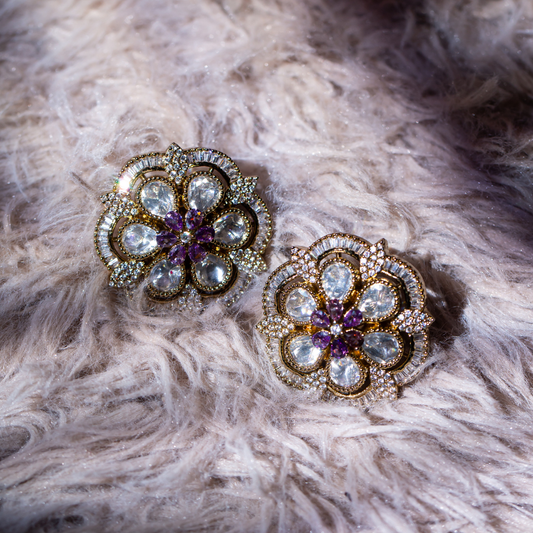 the numa studs gold plated floral shaped studs with crystal and lilac detailing.