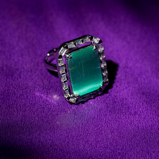 The Ocean Blue Ring featuring a cool blue stone and halo detail

