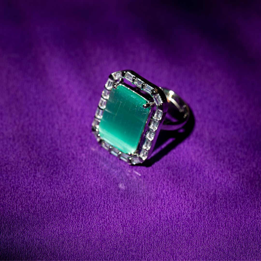 The Ocean Blue Ring featuring a cool blue stone and halo detail

