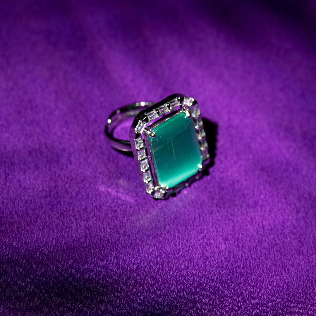 The Ocean Blue Ring featuring a cool blue stone and halo detail

