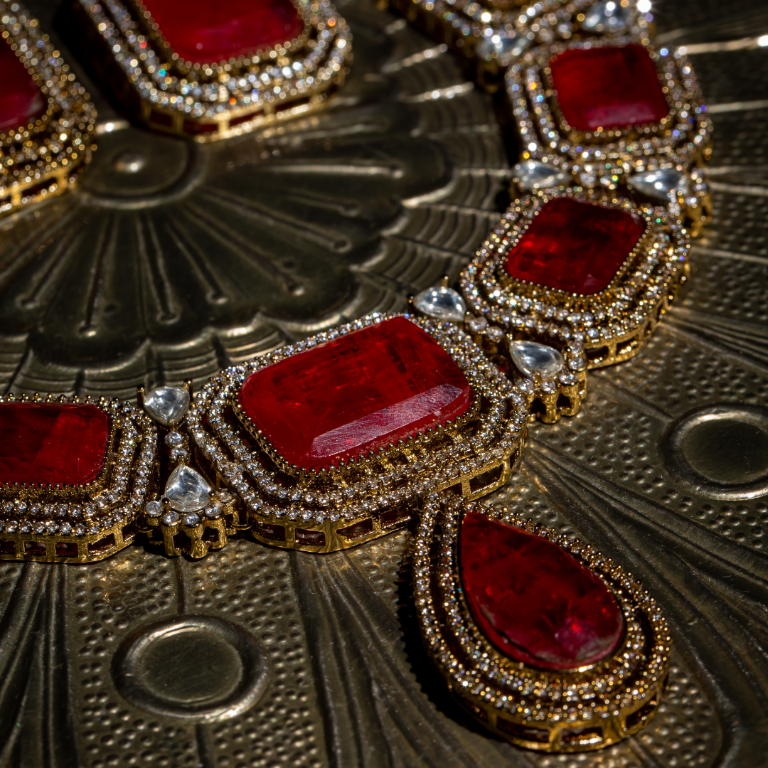 The Raga Necklace Set with red stones on gold base, includes matching earrings

