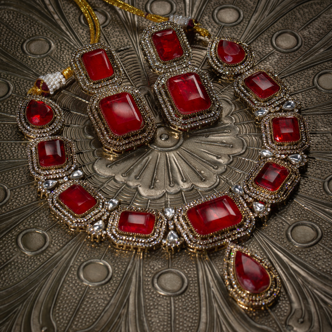 The Raga Necklace Set with red stones on gold base, includes matching earrings

