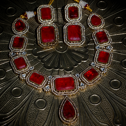 The Raga Necklace Set with red stones on gold base, includes matching earrings

