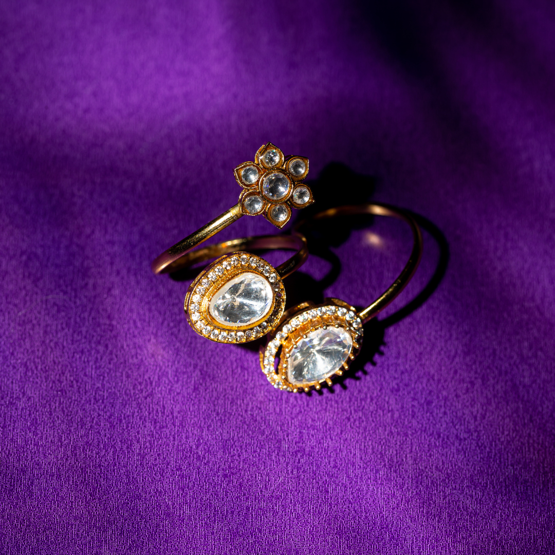 Gold plated double finger crystal ring with round and teardrop stones