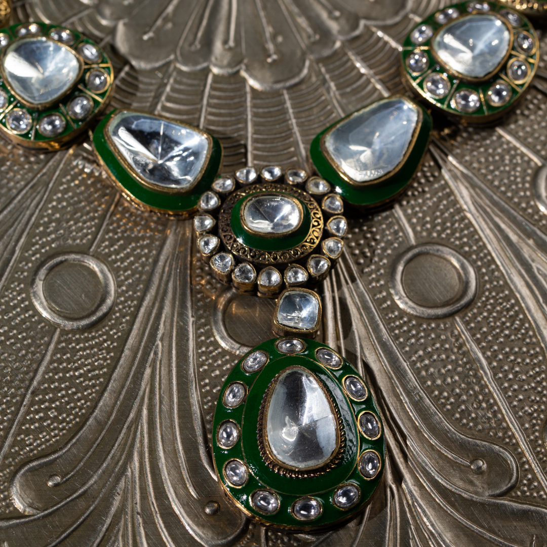 The Tarz Maala Set in green enamel and glass polki detailing on gold base, with matching earrings

